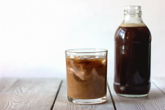 An image of a glass and bottle containing coffee, demonstrating the difference between cold brew vs iced coffee