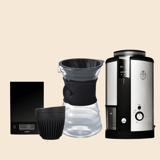 A V60 and wilfa grinder bundle that comes with a V60 coffee dripper, a wilfa grinder, a Huskee reusable cup and a Hario scale.