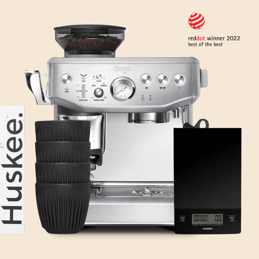 A Sage Barista Express Impress Home Barista Bundle that comes with A Sage coffee machine, four Huskee reusable coffee cups and a Hario scale 